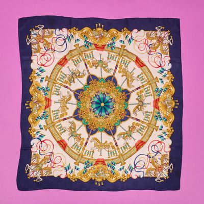 a close up of a square scarf with a clock on it