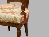 a wooden chair with a floral upholstered seat
