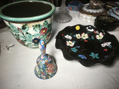 a vase and a bowl on a table next to each other