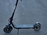 an electric scooter is parked on the pavement in a parking lot