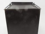an old black suitcase sitting on top of a white surface