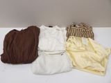 four pieces of clothing are laid out on a white table