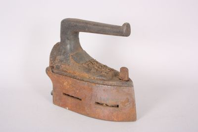 an old iron is sitting on a white surface with a white background