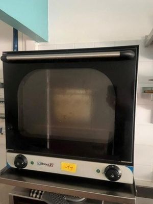 a microwave sitting on top of a table in a kitchen