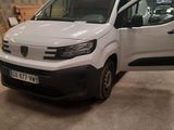the white van is parked in the garage with the door open