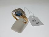 a gold ring with a blue stone on it and a price tag