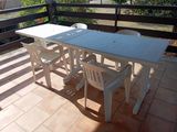 a white table and chairs on the balcony of a house