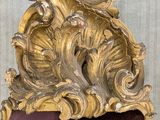 a mirror with a gold frame on a wall