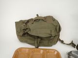 a bag and a tray of food sitting on a table