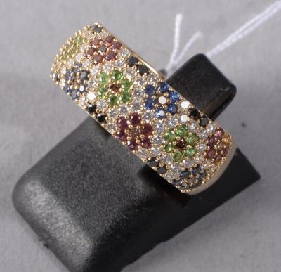 a close up of a gold ring with multi colored stones