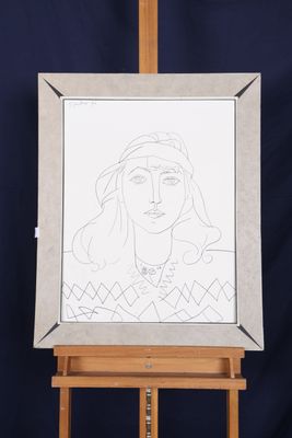 an easel with a drawing of a woman ' s face on it