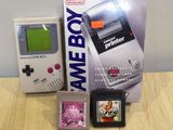 a nintendo game boy next to a nintendo game console