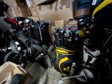 many golf clubs and bags in a room with boxes