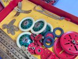 a red box filled with assorted tools on a blue table
