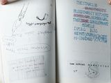 a person holding an open book with a drawing on it