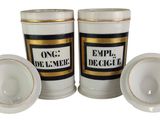two white cups with gold trims are sitting next to each other