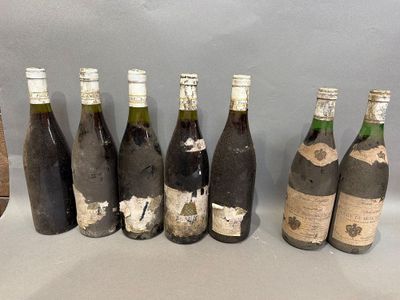 several bottles of wine are lined up on a table