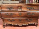 a wooden chest of drawers with a marble top