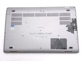 a silver laptop with a broken battery cover on it