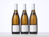 three bottles of wine sitting on top of a table next to each other