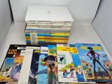a lot of comic books sitting on a table