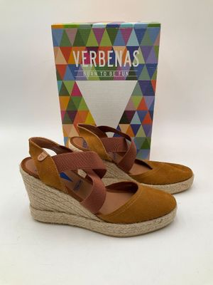 une paire de sandales à talons compensés avec un élément en forme de boîte sur le côté
