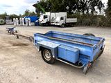 a blue trailer with a trailer attached to it