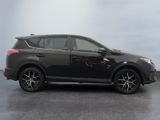 the black toyota rav is parked in a parking lot