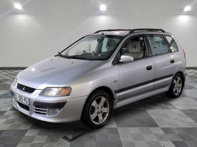 a picture of a silver car parked in a garage