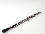 a close up of a clarinet on a white surface