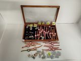 a wooden box filled with assorted items on a white surface