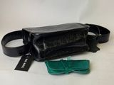 black and green purse with a bow tie on a white background