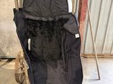 a baby stroller with a black cover in a garage