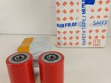 two red rollers are sitting next to a box of red tape