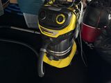 a yellow vacuum cleaner sitting on the floor next to a pile of boxes