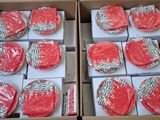 several boxes of red and white soap sitting on top of a table
