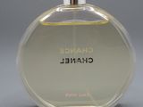 a close up of a bottle of perfume on a gray surface