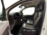 the interior of a white truck with the door open and the driver ' s seat down