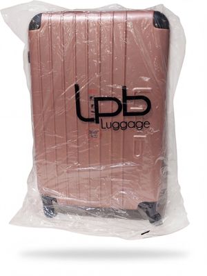 a piece of luggage wrapped in plastic on a white surface