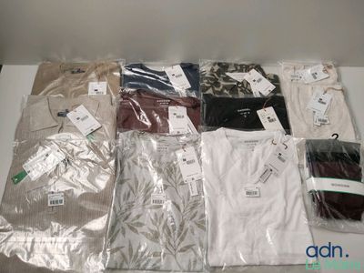 a lot of men ' s shirts on a table