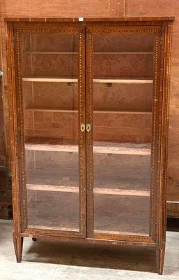 an old wooden cabinet with glass doors in a room
