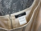 a label on the back of a dress with a lace pattern