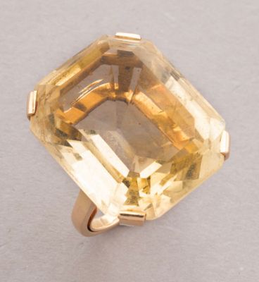 an image of a yellow topazte ring on a white surface