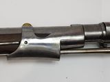 a gun that is sitting on a white surface