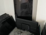 a television that is sitting on the floor next to a toaster oven