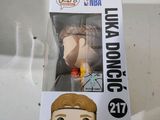 funko pop vinyl figure in a box with a basketball player on it