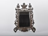 an antique mirror with ornate design on a white background