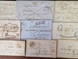 several old letters and envelopes on a wooden table