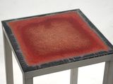 an image of a small table with a red square on top of it