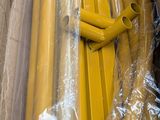 a box with a bunch of yellow pipes wrapped in plastic
